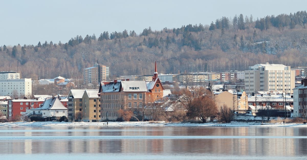 Captivating winter cityscape of Jönköping, Sweden, featuring snow-covered buildings along the lakeshore.