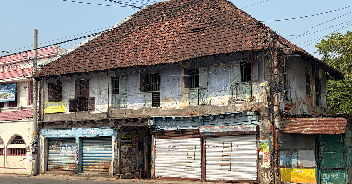 Comfort Hotel Kochi in Kochi: Fresh 2018 Build Across from JR Kochi Station An aged colonial building with rusted shutters in Kochi, Kerala, India, showing rustic charm.
