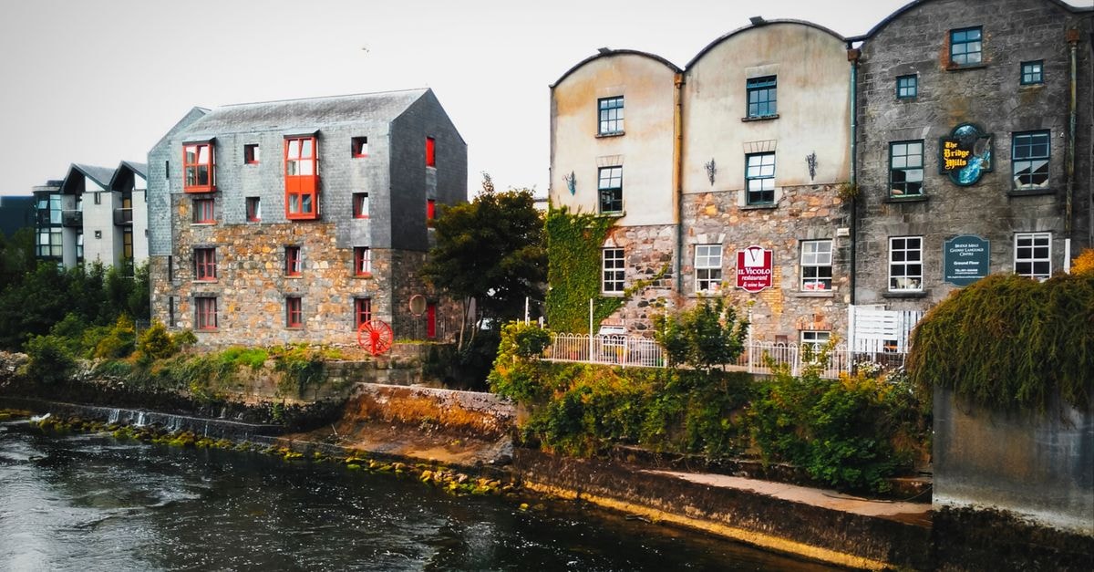 The Imperial Hotel, Galway — A Central Stay on Eyre Square Charming stone buildings along the river in Galway, Ireland, showcasing traditional architecture and scenic views.