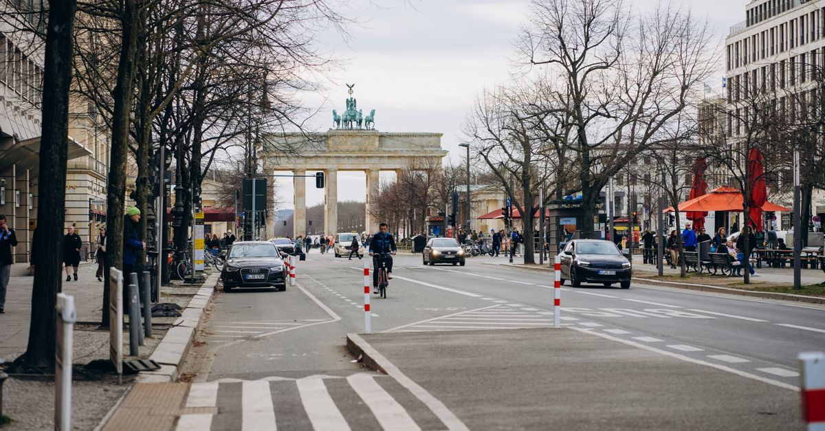 Berlin July 2026 Travel Guide: Practical Tips for the Busy Summer Month Street scene with Brandenburg Gate in Berlin, showcasing urban life and historic architecture.