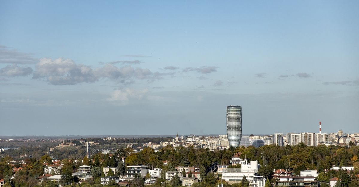 Ramada by Wyndham Zalău, Romania — Central Stay Steps from 1 December 1918 Square Aerial view of Belgrade cityscape featuring modern skyscrapers and lush urban greenery.
