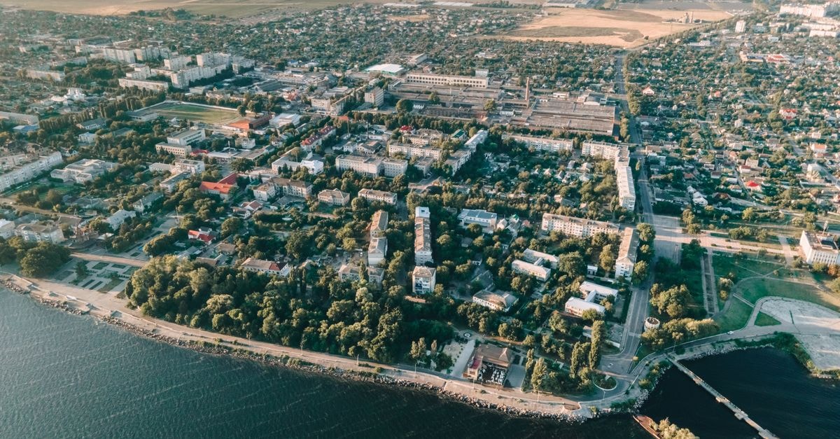 Optima Суми in Sumy: A Business Hotel Reopens on Voskresenska Street A breathtaking aerial view of a coastal city showcasing lush greenery and urban landscapes.