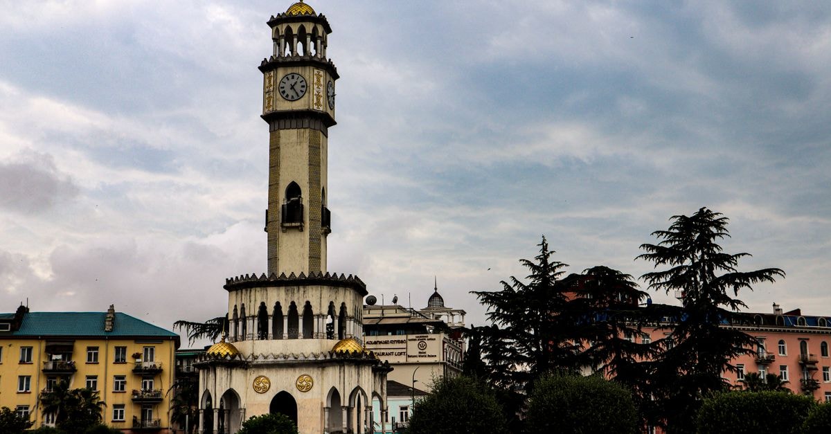 Daisi-Sunset in Batumi: A Quiet New Stay Near the Sea Chacha Clock Tower in Batumi, Georgia, surrounded by urban architecture and greenery.