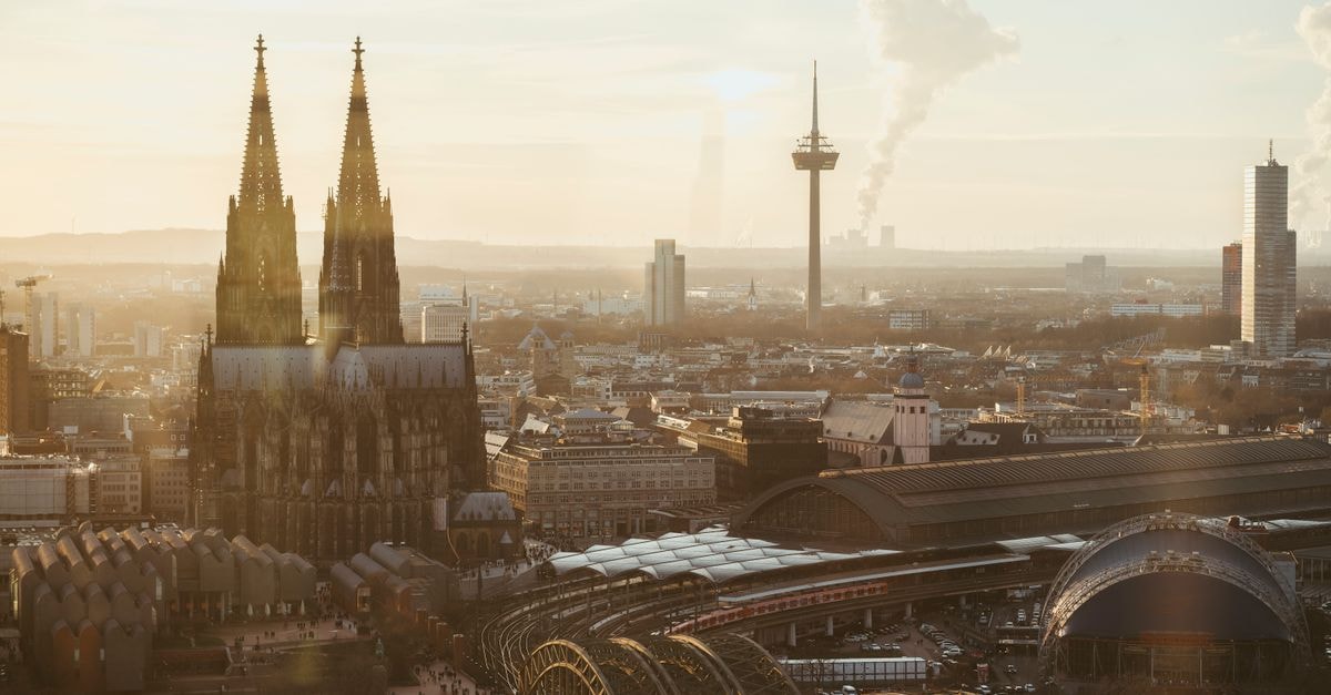 Cologne Travel Guide: Cathedral Views, Museum Ludwig, and Rheinland Cuisine A breathtaking view of Cologne Cathedral at sunrise, surrounded by urban cityscape.
