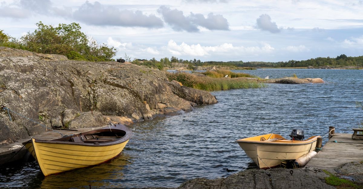 Turku Travel Guide: Planning Tips, Costs and Things to Do Charming scene of boats docked by rocky shore in Turku Archipelago, Finland.