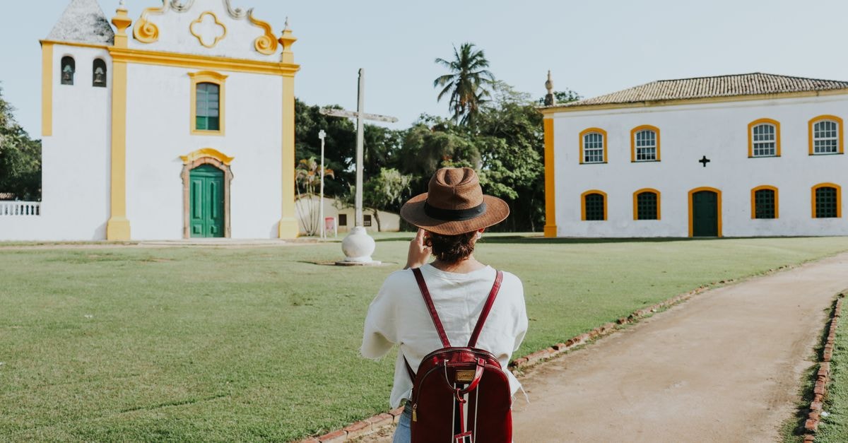 Traveler taking photos of a historic church in Porto Seguro, Bahia, Brazil.