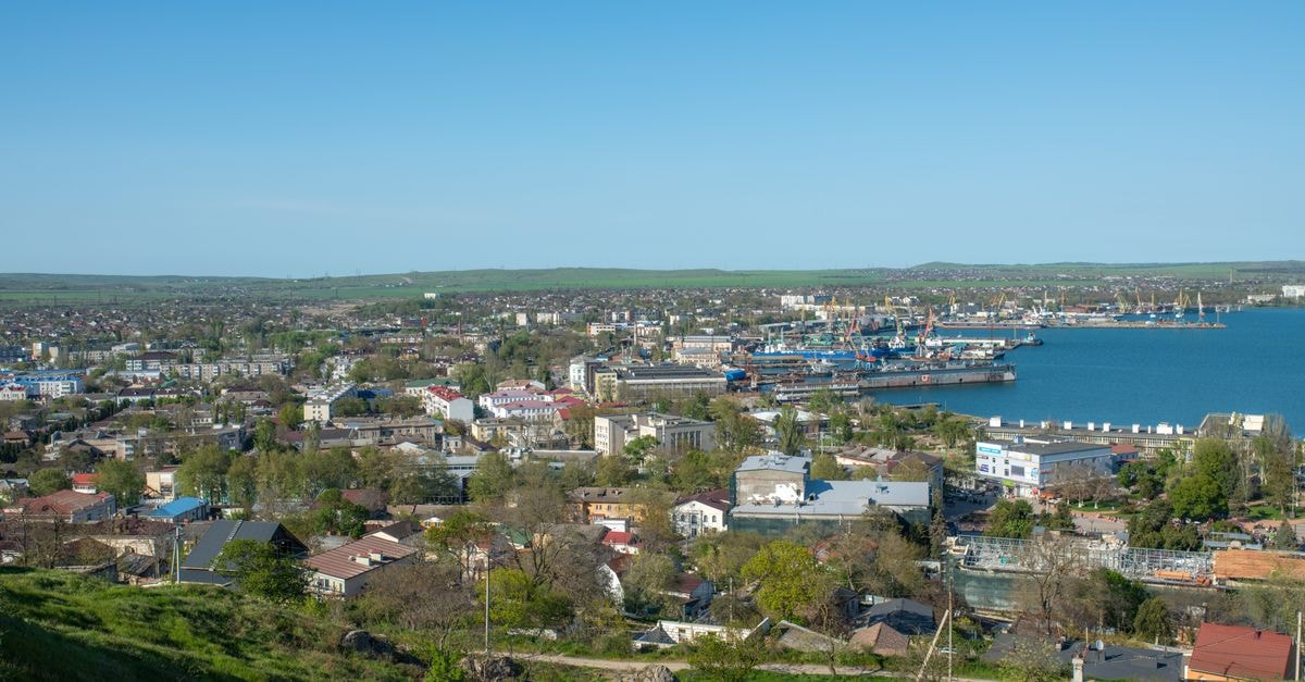 Odesa Travel Guide: Planning Tips, Costs and Things to Do A stunning view of the cityscape and harbor in Kerch, captured on a clear summer day.
