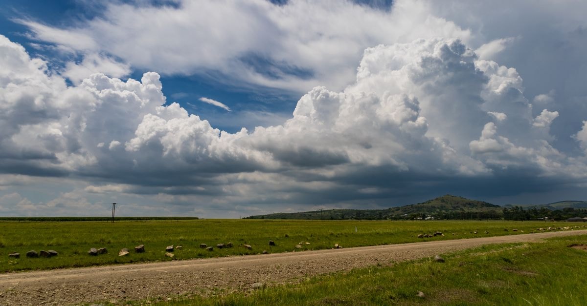 Newcastle Travel Guide: A Quiet KwaZulu-Natal Foothills Stop Scenic expanse of cumulus clouds over a rural road in Ephangweni, South Africa.