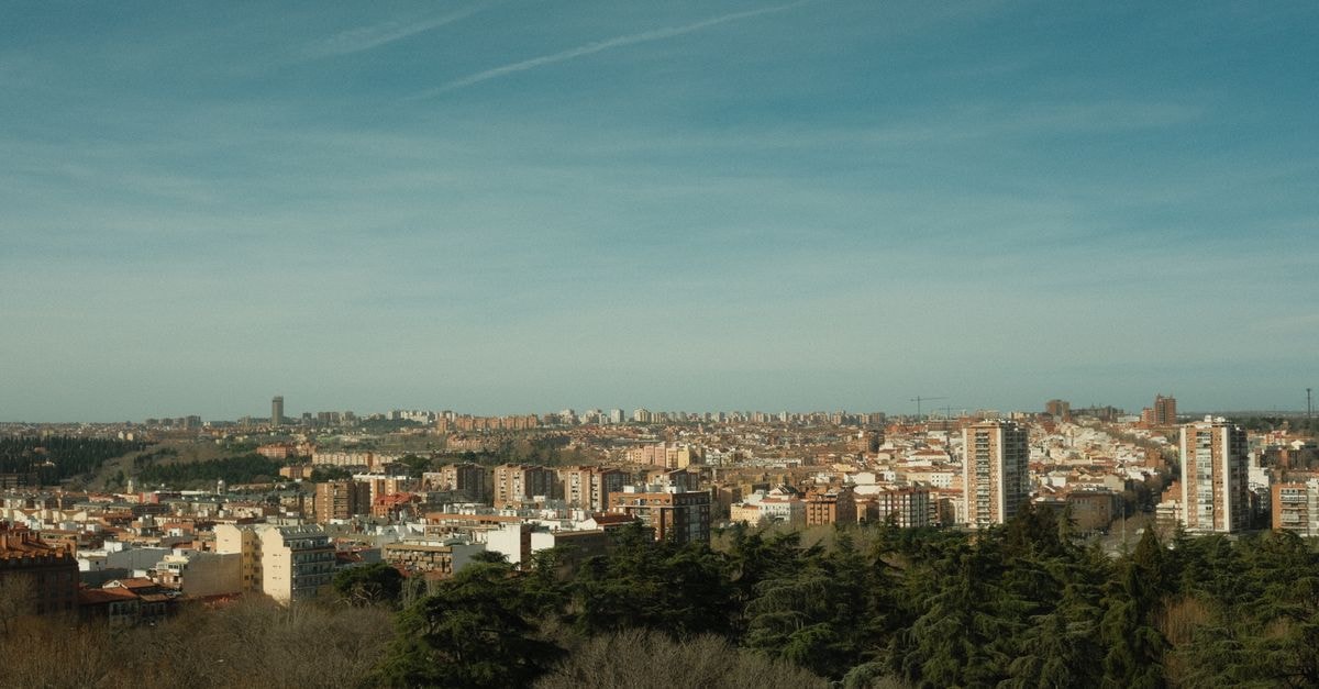 Hotel Lamas in Santa Lucía: A Long-Standing Stay in Canelones Aerial view of a city with surrounding forests under a bright blue sky.