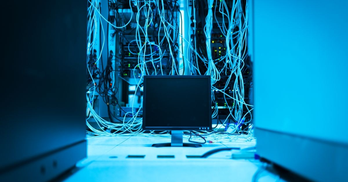 Comcast Technology Solutions unveils end-to-end Video AI applications ahead of IBC 2026 A complex network of cables in a data center with a monitor in the foreground.