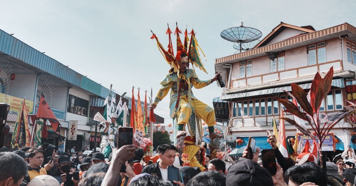 Hotel Sinar Khatulistiwa in Singkawang: A Handy Base Near the City's Bustling Streets Vibrant traditional festival parade in Singkawang, West Kalimantan, featuring colorful costumes and crowd.
