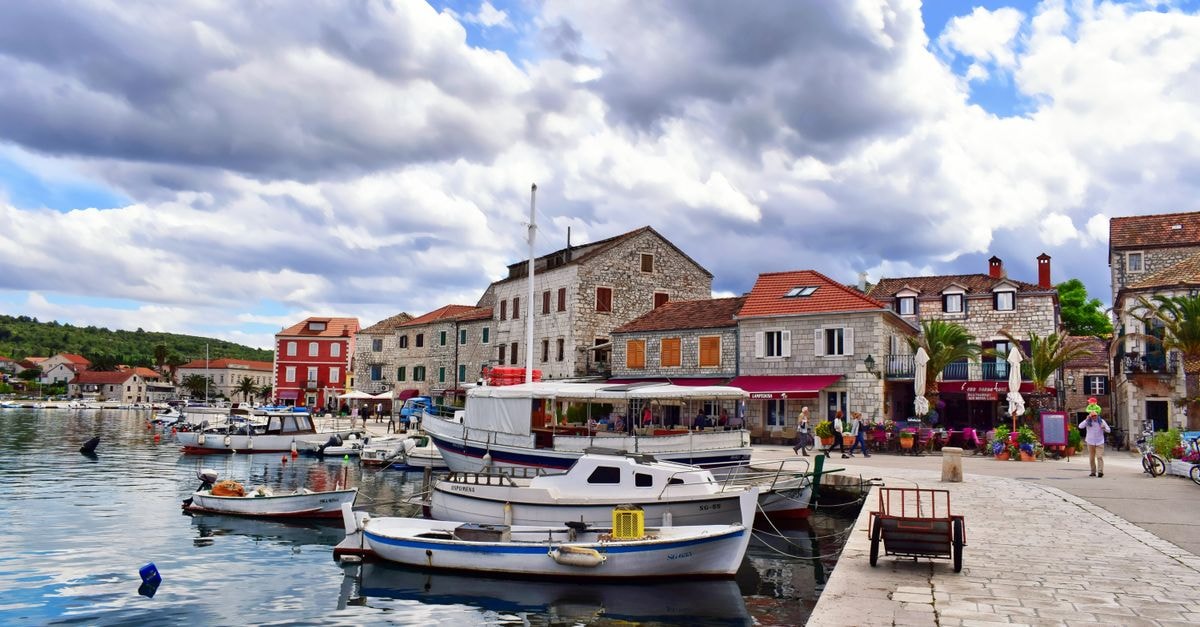 Dobrich Travel Guide: Planning Tips, Costs and Things to Do Picturesque harbor view in Split-Dalmatia, Croatia with docked boats and charming stone buildings.