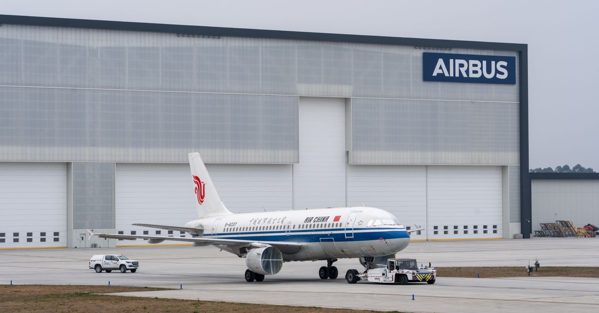 China Inspects XPeng and Aion Plants as Global EV Industry Posts Major Moves Air China aircraft being towed in front of Airbus hangar.