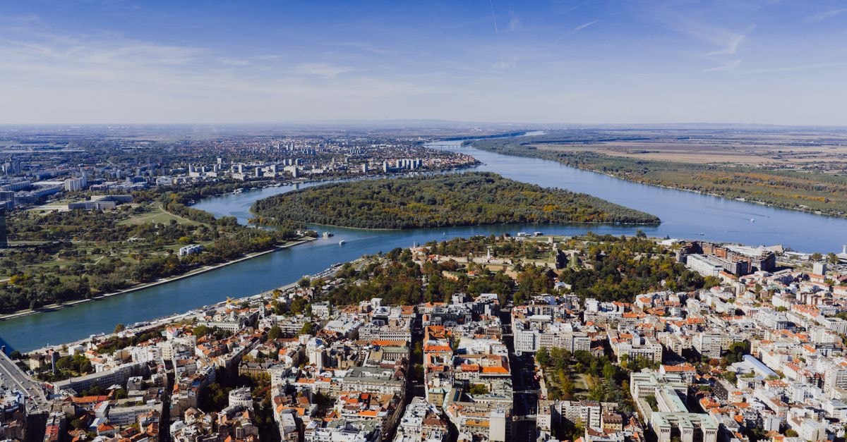 Hilton Belgrade in Serbia — A Royal Address on Kralja Milana Aerial view showcasing the cityscape of Belgrade, Serbia with the Danube River winding through the landscape.