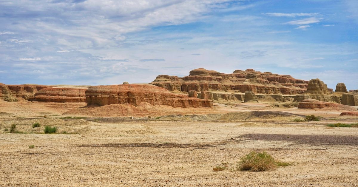 Breathtaking view of red rock formations in a desert landscape beneath a clear blue sky, perfect for nature and travel themes.