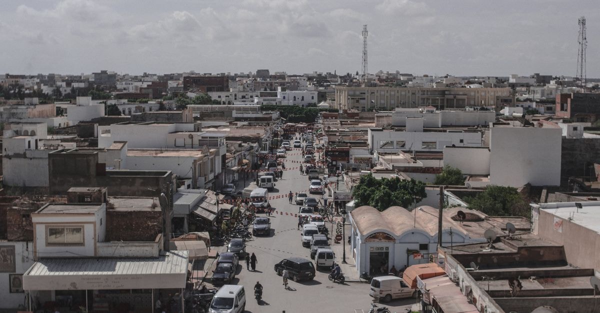 Bab Al Bahar Hotel & Spa in Dakhla: Boulevard Mohamed V Address A bustling urban street in a town with cars and buildings, captured from above.