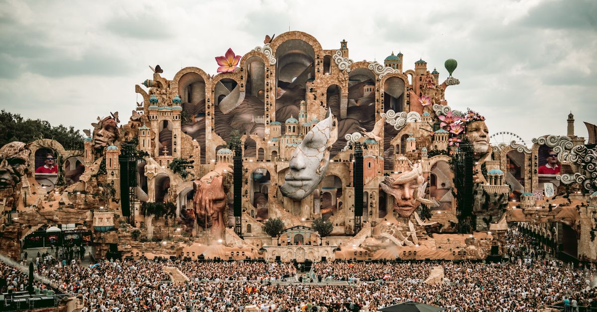 Martin Garrix and U2 Release Collaborative Single 'Fireflies' Following Tomorrowland Debut A breathtaking view of the Tomorrowland festival stage in Boom, Belgium, filled with vibrant decorations and a massive crowd.