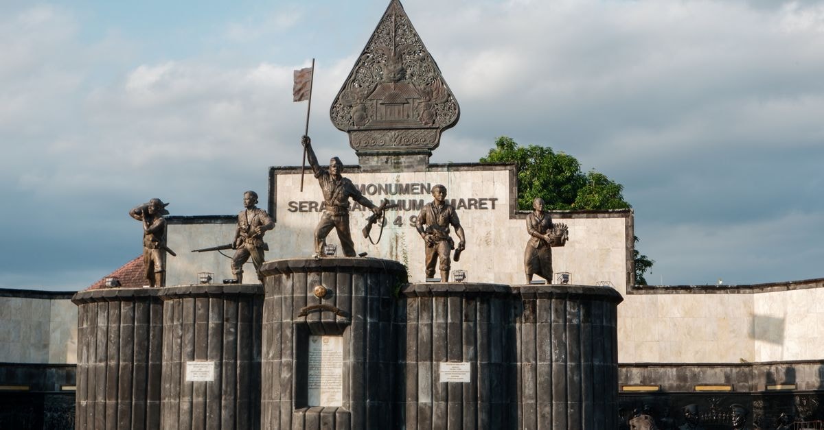 A striking view of Serangan Umum 1 Maret Monument under a cloudy sky in Yogyakarta, Indonesia.