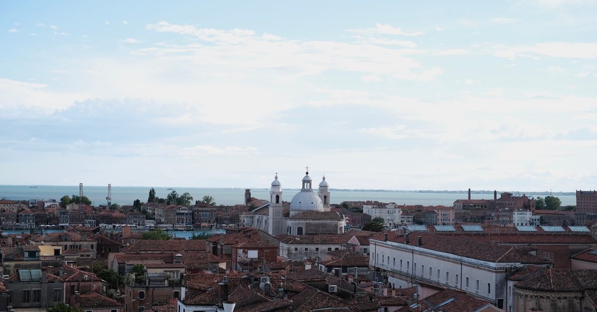 Locanda Sturion Venice: 13th-Century Inn Overlooking the Grand Canal Stunning aerial view of Venice showcasing historic architecture and the vibrant cityscape.