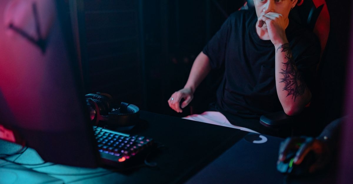 COLORFUL Launches iGame X870E ULTRA-S V14 Motherboard in India Young man intensely focused on a gaming session at night, highlighting the competitive esports atmosphere.