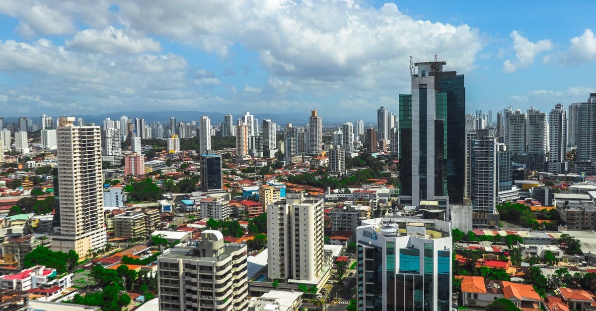 Panoramic view of Panama city's vibrant skyline showcasing modern skyscrapers against a bright sky.