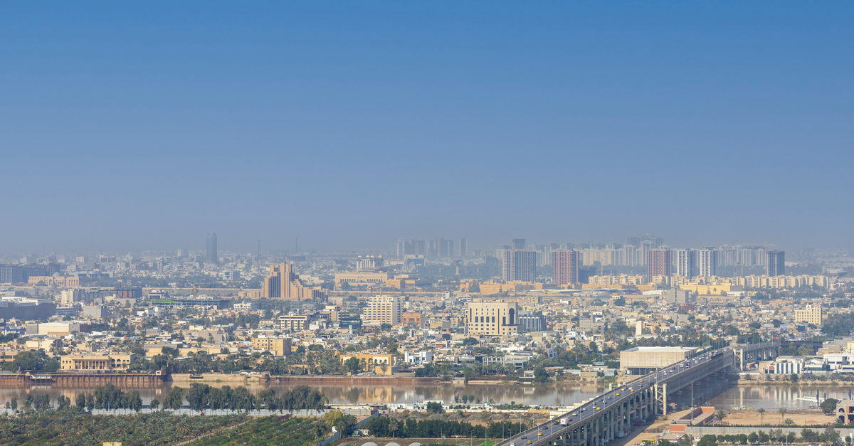 Breathtaking aerial view of Baghdad cityscape with Tigris River, showcasing urban architecture.