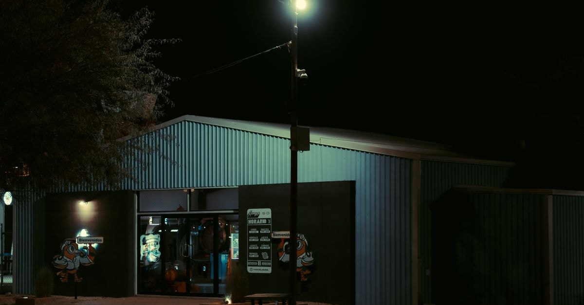Explore the urban ambiance of a secluded Hermosillo store at night, glowing under streetlights.