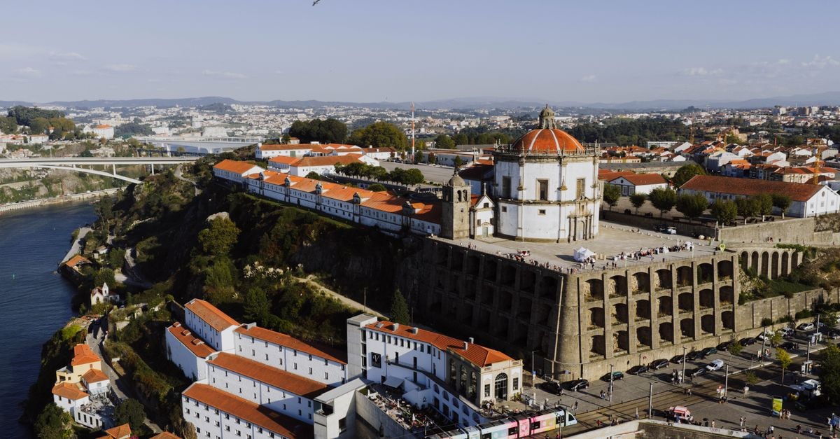 A stunning aerial view of Porto's Monastery of Serra do Pilar at sunset, showcasing its iconic architecture.