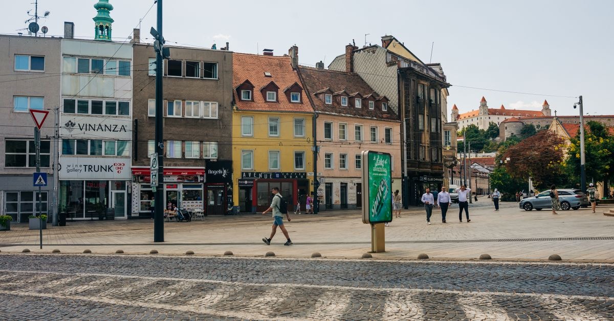 A vibrant day in Bratislava city center, showcasing historic architecture and street life.