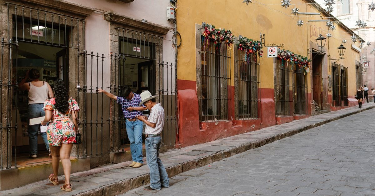 Charming street view with people walking in San Miguel de Allende, Mexico.