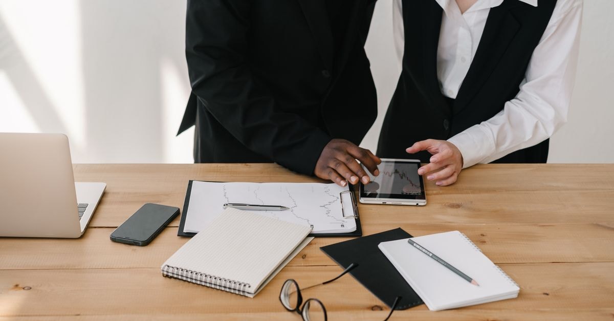 Samsung's Fold 8 vs. Fold 8 Ultra divide comes into focus after extended hands-on reviews Two professionals collaborating over charts and tablet in a modern office setting.