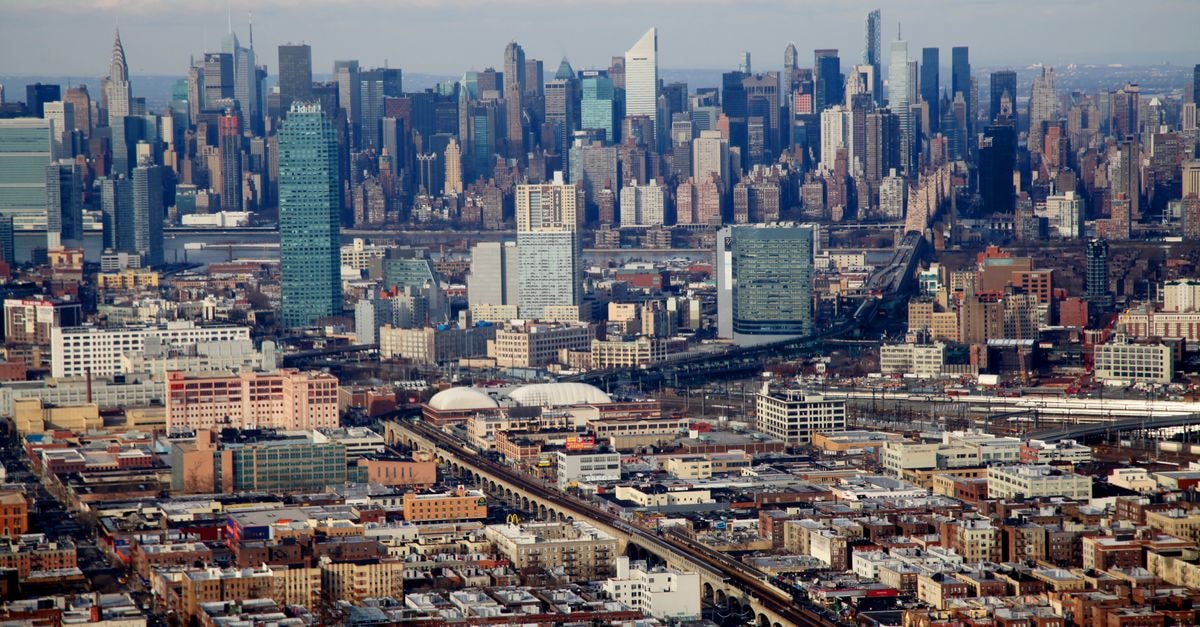 The Bronx Travel Guide: Getting Around, Seeing the Borough and Eating Well Stunning aerial view of the Manhattan skyline under a clear day in New York City, USA.