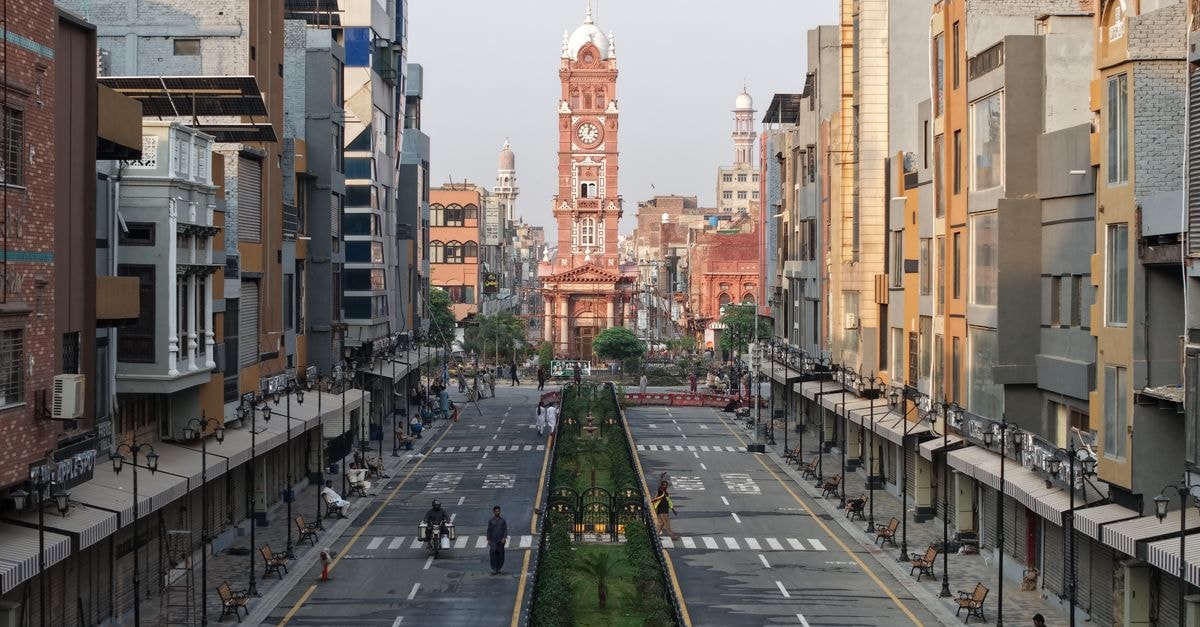 Q's International in Sargodha: A Lively University Road Address Worth Knowing Bustling scene of Faisalabad's iconic Clock Tower area, with vibrant city life and architecture.