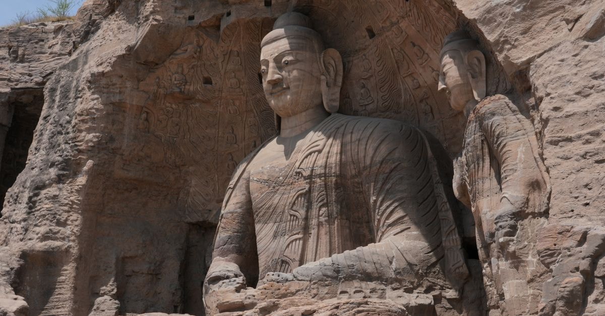 Tiangui International Hotel, Datong — A Northern Wei Cultural Theme Stay Ancient stone Buddha statues carved into the cliffs at Yungang Grottoes in Datong, China.