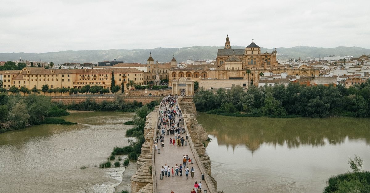 Eurostars Azahar in Córdoba: A Calm Stay Near Claudio Marcelo View of the busy Roman Bridge leading to the iconic Mosque-Cathedral in Córdoba, Spain.