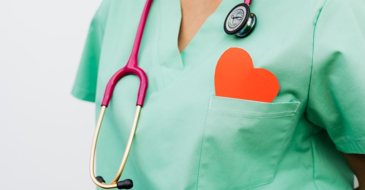 U.S. Physical Therapy: Service Engine With a Heavy Earnout Footprint A healthcare professional with a stethoscope and red heart symbol emphasizes cardiology care.