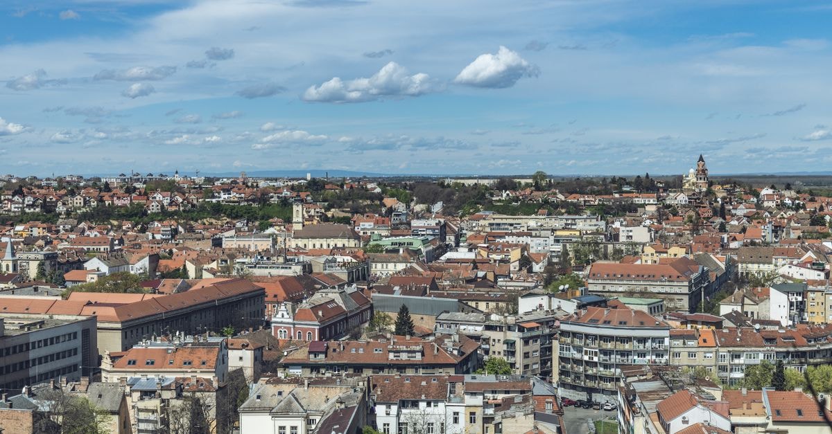 A Slow-Travel Guide to Novi Sad, Serbia's Quiet Cultural Capital Panoramic aerial view of Belgrade cityscape with traditional architecture under clear skies.