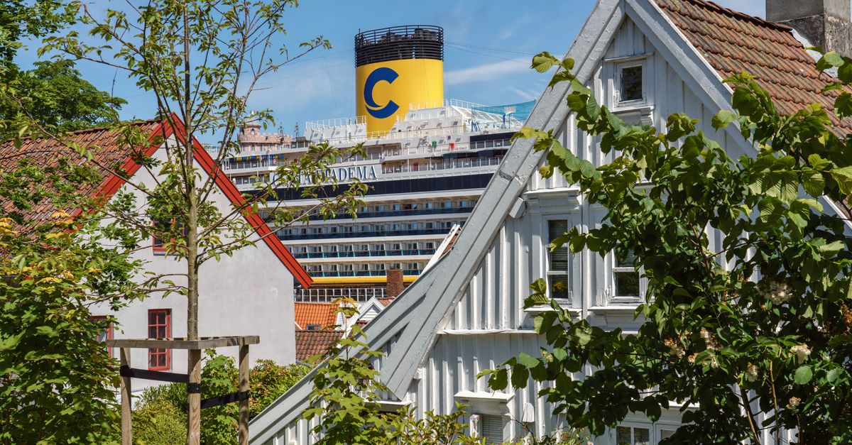 Picturesque residential houses in Stavanger with a cruise ship in the background, capturing urban and maritime blend.