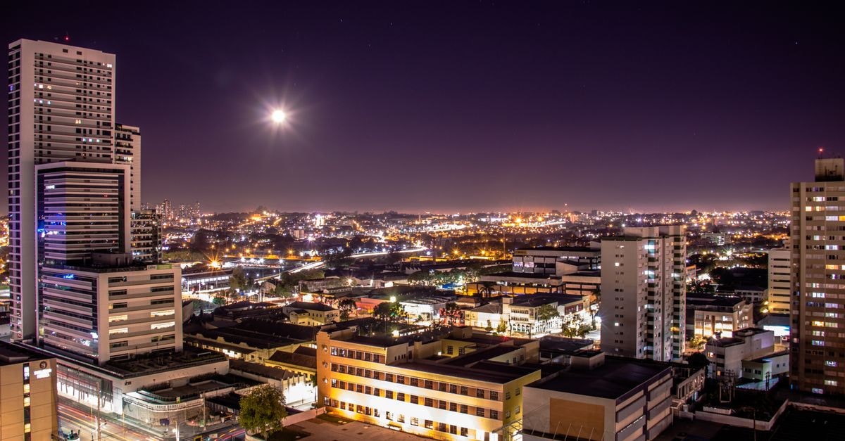 Stunning aerial view of Curitiba at night showcasing illuminated skyscrapers and vibrant city life.