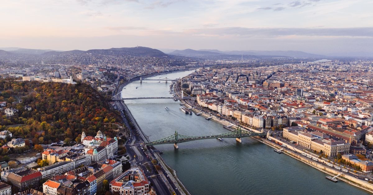 Beautiful aerial view of Budapest with the Danube River and iconic bridges at sunset.
