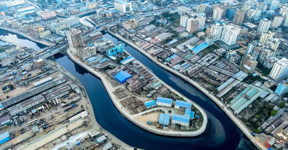 A vibrant aerial view showcases the dynamic cityscape and canal system in Chattogram, Bangladesh.