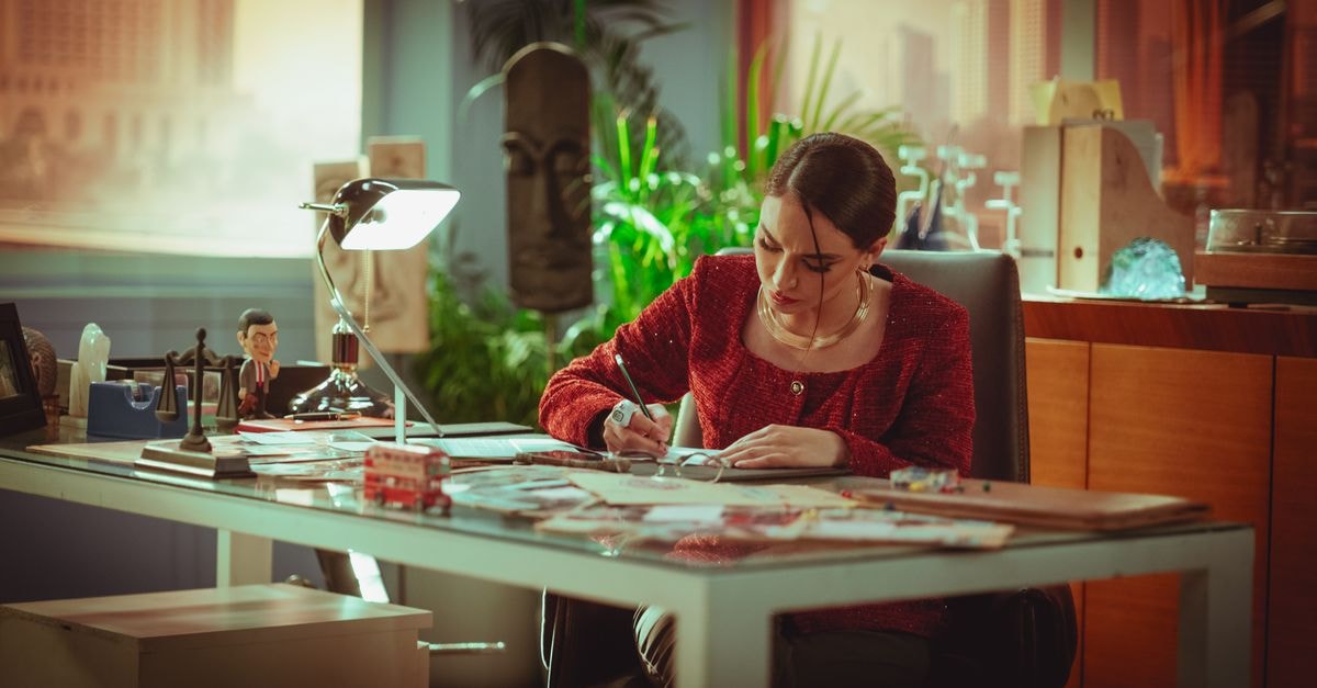 Al Mansour Hotel in Baghdad: A 1980 Landmark on Haifa Street A professional woman working diligently at a desk in an office setting, Baghdad.
