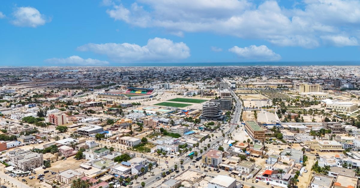 Hôtel Eden Stop in Ain Temouchent: A Central Base Near Parc National Stunning aerial shot of Nouakchott, Mauritania, showcasing urban sprawl under a bright blue sky.