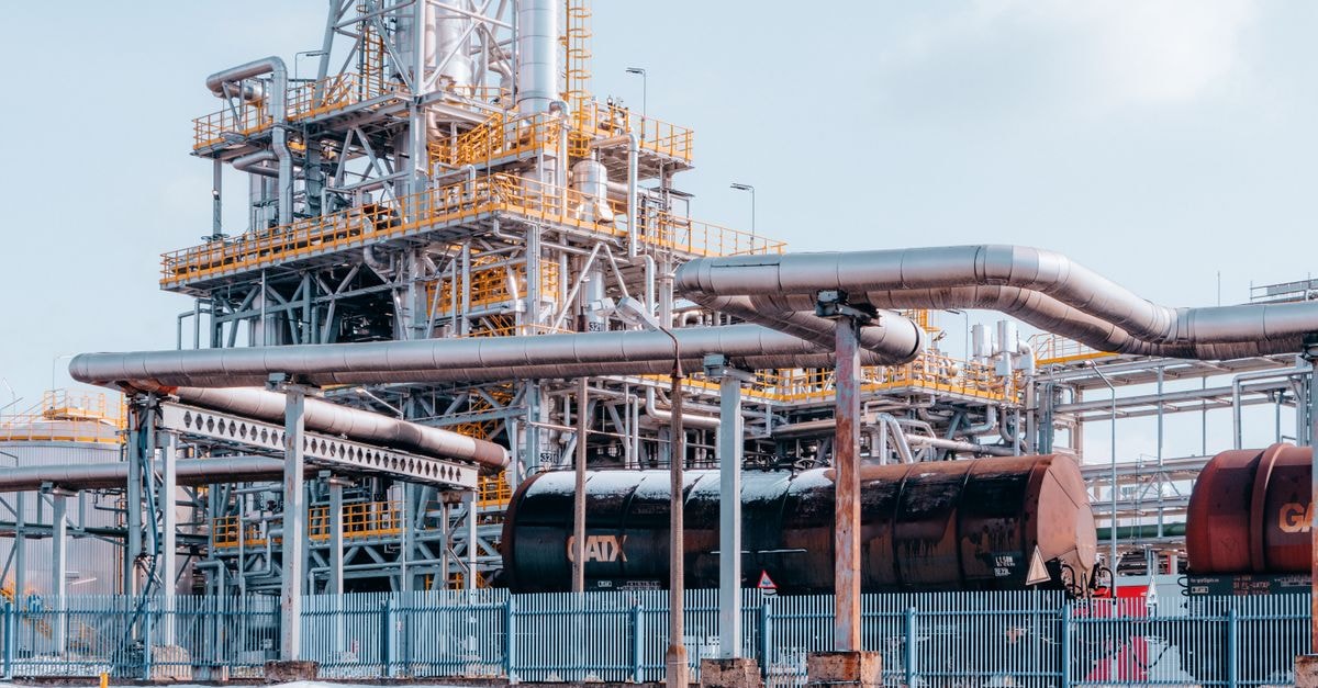 LG Energy Solution signs 10-year US lithium carbonate offtake with Smackover Lithium Oil refinery facility with tanker wagons in Trzebinia, Lesser Poland Voivodeship under a clear sky.
