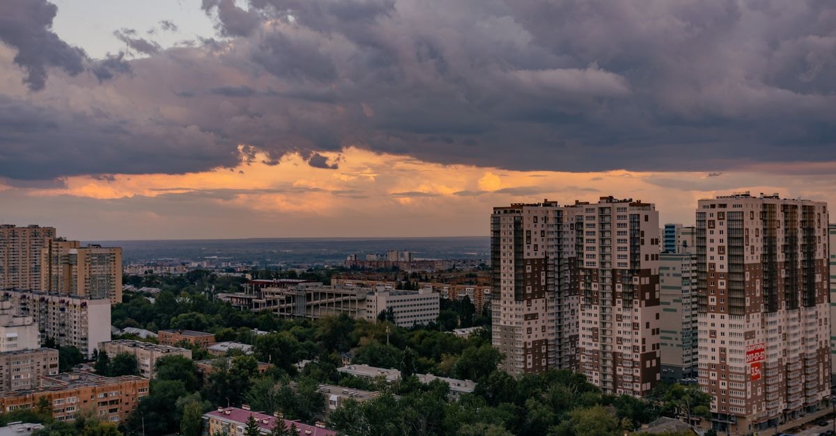 Ramada Donetsk in Donetsk: The Only Networked Hotel in the City A striking view of city buildings under a dramatic sunset sky.