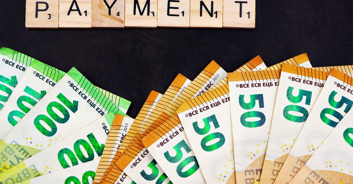 Stryker pays $400M for CMR equity and U.S. agency Euro banknotes fanned out with 'PAYMENT' spelled in Scrabble tiles, representing finance and commerce.