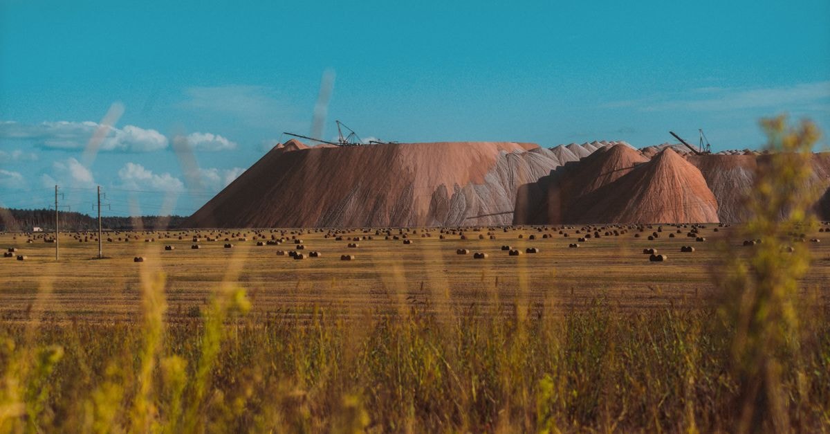 Blue Moon Metals to acquire 33 U.S. tungsten and antimony projects for US$20.5 million Vast field landscape with salt mines in Salihorsk, Belarus under a clear blue sky.