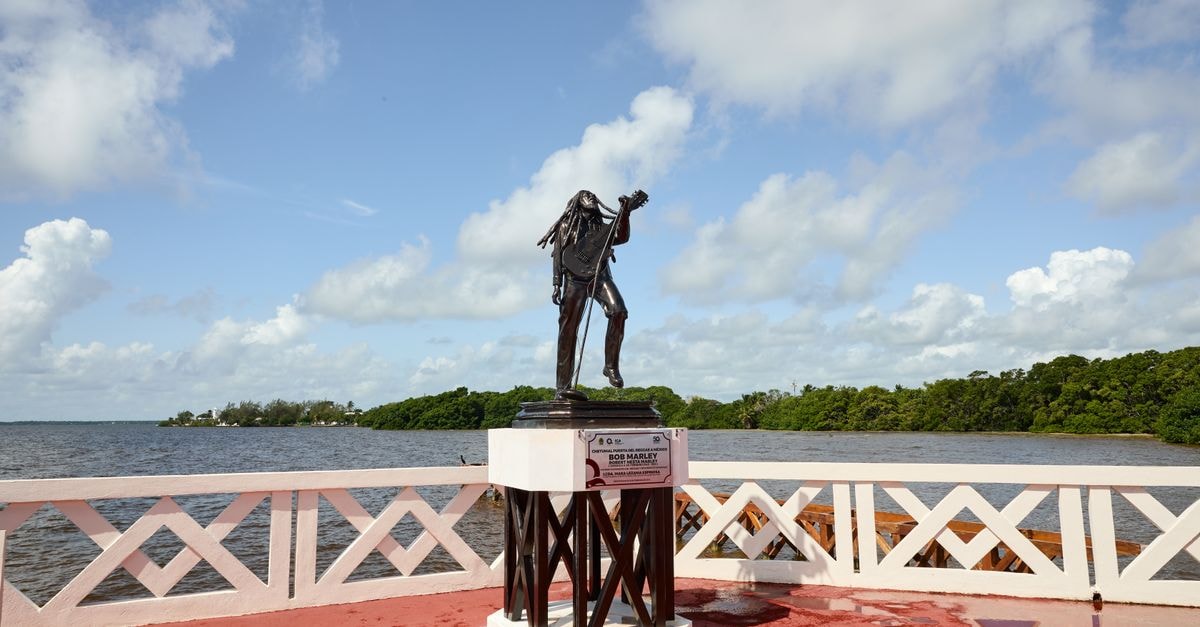 Chetumal Travel Guide: Caribbean Calm on Mexico's Quiet Coast Statue of Bob Marley surrounded by vibrant scenery at Chetumal Bay, Quintana Roo, Mexico.