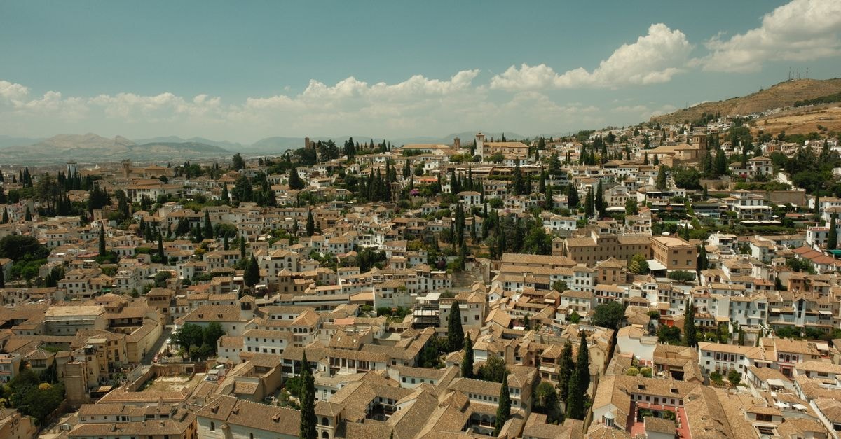Socialtel Granada, Nicaragua — A Social Stay in the Heart of Town Aerial view of the historic Albayzín District in Granada, Spain, showcasing traditional Moorish architecture.