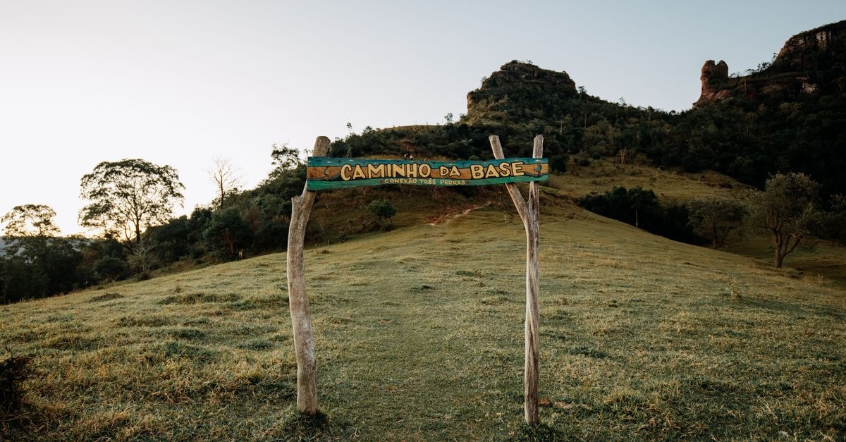 Vitória da Conquista Travel Guide: History, Trails and Bahian Flavor Trail entrance at Caminho da Base amidst scenic Brazilian landscape, lush greenery.